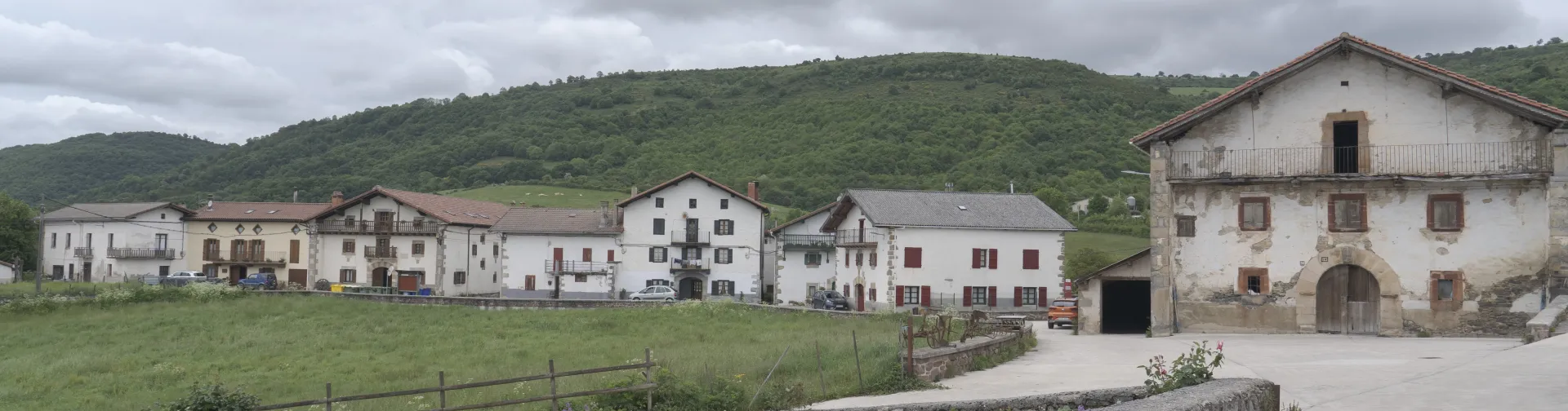 Caseríos tradicionales de Bizkarreta-Gerendiain en el Pirineo navarro, con muros delimitando prados.
