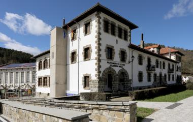 Ayuntamiento de Ezcaroz con arquitectura tradicional pirenaica, fachada blanca y sillería de piedra oscura.