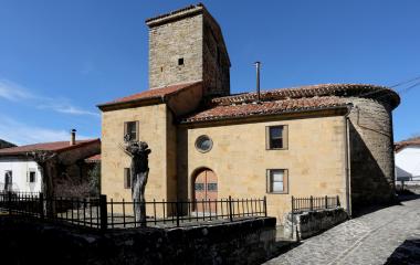 Iglesia de piedra con campanario cuadrado en Sarries, arquitectura tradicional pirenaica con tejado de tejas.